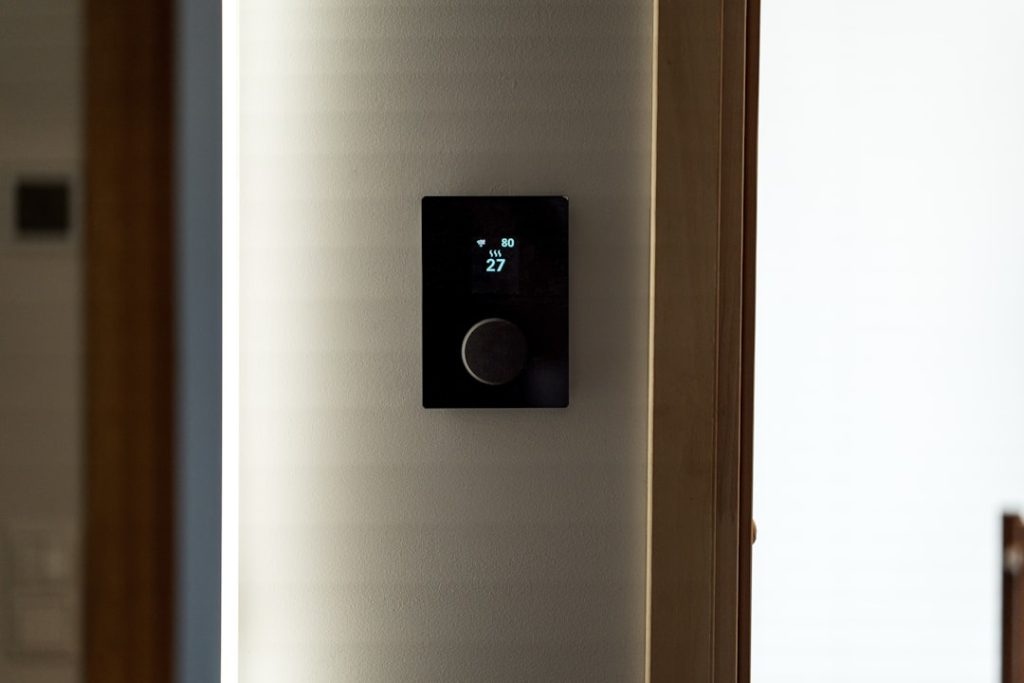 smart thermostat on wall smart home energy efficiency HVAC control