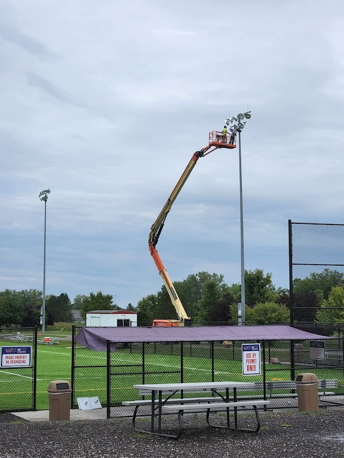 Electrical crew using a boom lift to service athletic field lighting in Northeast Ohio